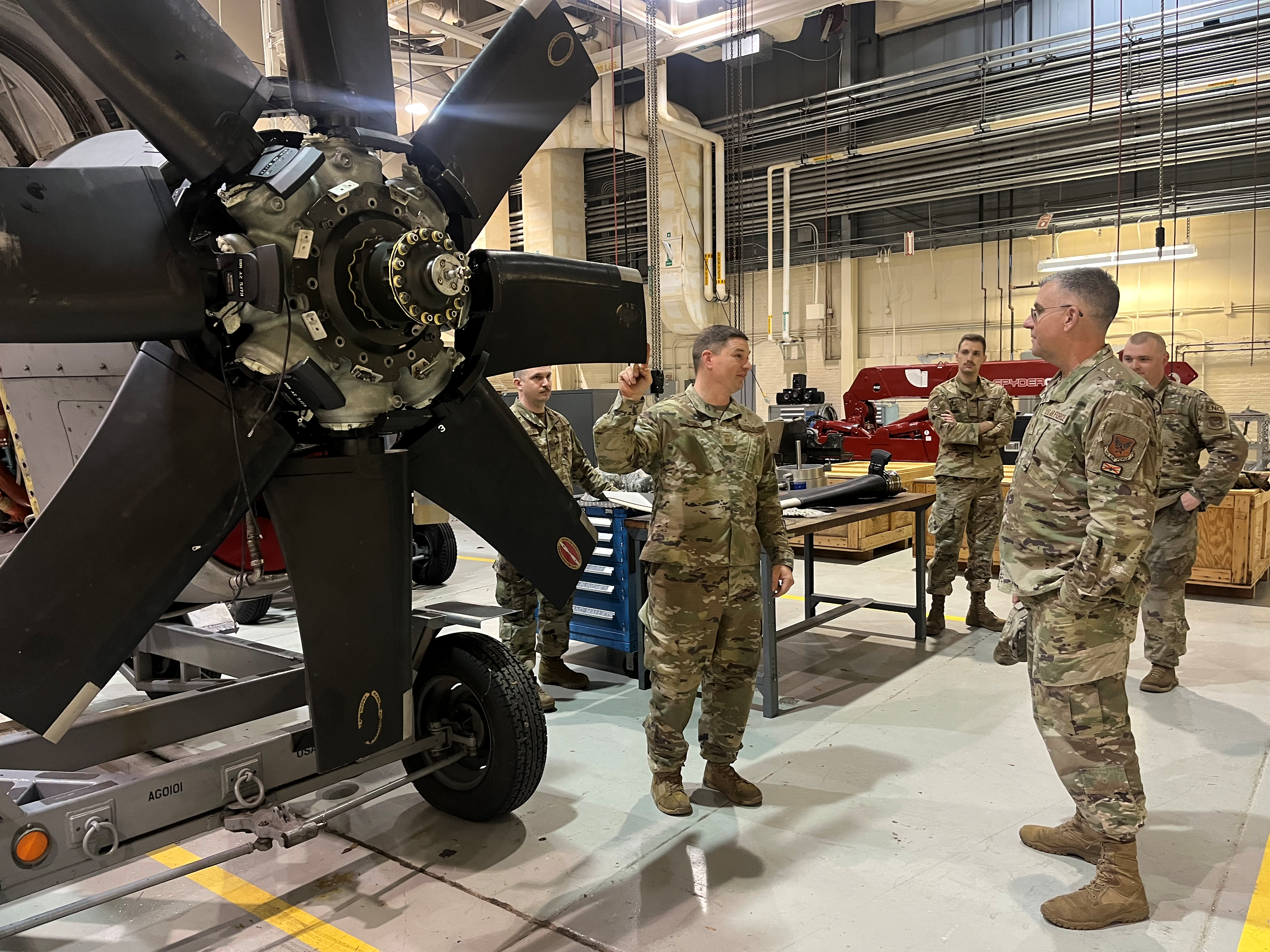 Brig. Gen. James Hartle, U.S. Air Force Associate Director of Logistics and Deputy Chief of Staff for Logistics, Engineering and Force Protection Directorate, right, looks on as Master Sgt. Timothy Robison, 94th Maintenance Squadron  Propulsion Flight Chief, discusses the capabilities of the upgraded NP2000 propeller during a unit immersion visit to Dobbins Air Reserve Base, Ga., on March 1, 2024. Th visit was an opportunity for 94th MXG Airmen to showcase their mission and innovation successes to a senior leader within the career field. (U.S. Air Force photo by Capt. Paris Krula)