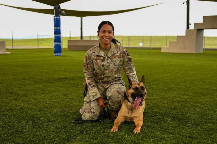 U.S. Air Force Senior Airman Gracia Bolainez, 9th Security Forces Squadron K-9 handler, and U.S Air Force Military Working Dog (MWD) Azur pose for a portrait at the kennel on Beale Air Force Base, California, Feb. 29, 2024.