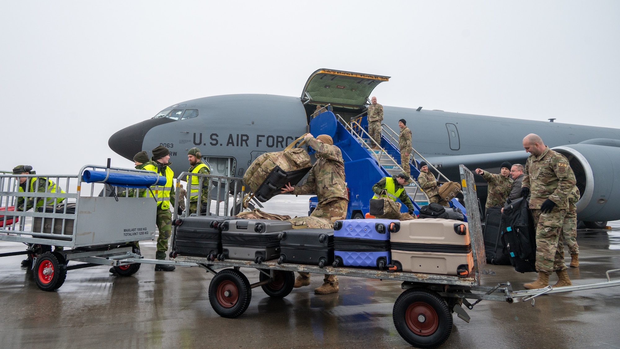 U.S. Air Force Reservists assigned to Niagara Falls Air Reserve Station offload luggage with Swedish Air Force air terminal platoon members at Luleå-Kallax Air Base, Sweden, Mar. 2, 2024.