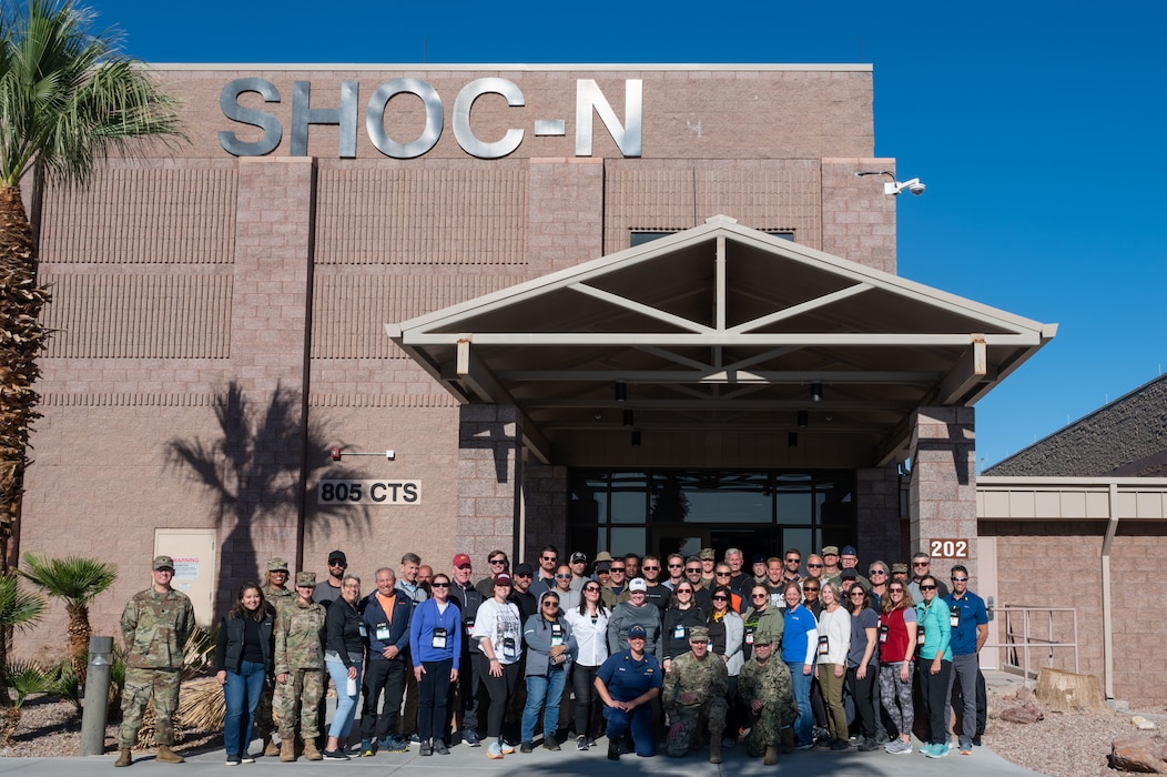 Members of the Joint Civilian Orientation Conference pose for a group photo in front of the Shadow Operations Center-Nellis during the programs 93rd iteration tour at Nellis Air Force Base, Nevada, Oct. 26, 2022. The ShOC-N is Air Combat Command’s focal point for experimentation, rapid development, and test support to Joint All-Domain Command and Control. (U.S. Air Force photo by Airman 1st Class Makenna Gott)