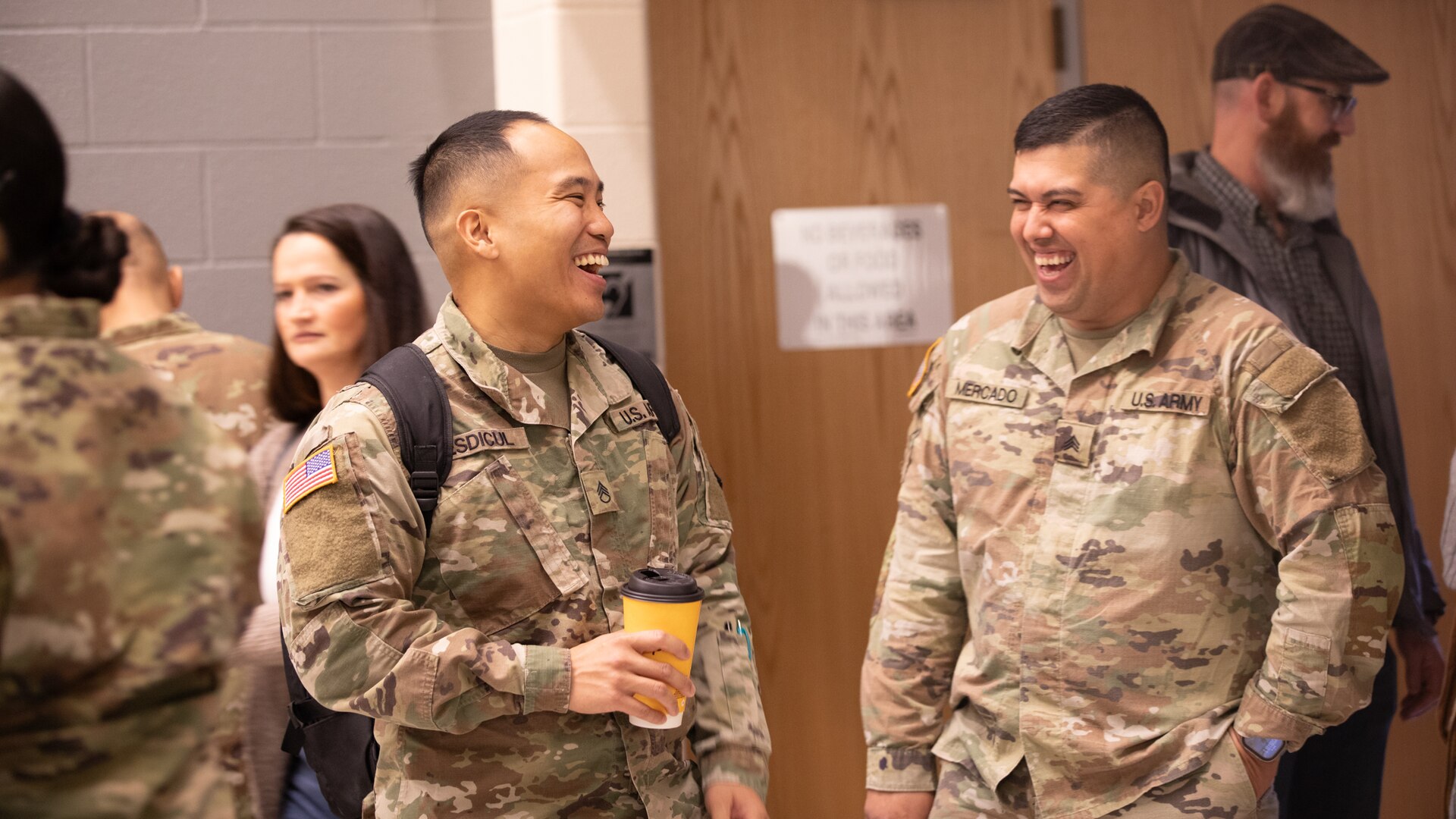 Soldiers with the 933rd Military Company laugh together March 9th after a welcome home ceremony at the College of Lake County, in Grayslake, Illinois. The 933rd Military Police company deployed to U.S. Southern Command Area of Responsibility from January 2023 to November 2023.