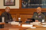 Dr. Sandeep Mulgund, Headquarters Air Force senior advisor to the deputy chief of staff for operations, speaks with U.S. Air Force Lt. Gen. Brian S. Robinson, commander of Air Education and Training Command, during a visit to AETC headquarters at Joint Base San Antonio-Randolph, Texas, March 7, 2024.