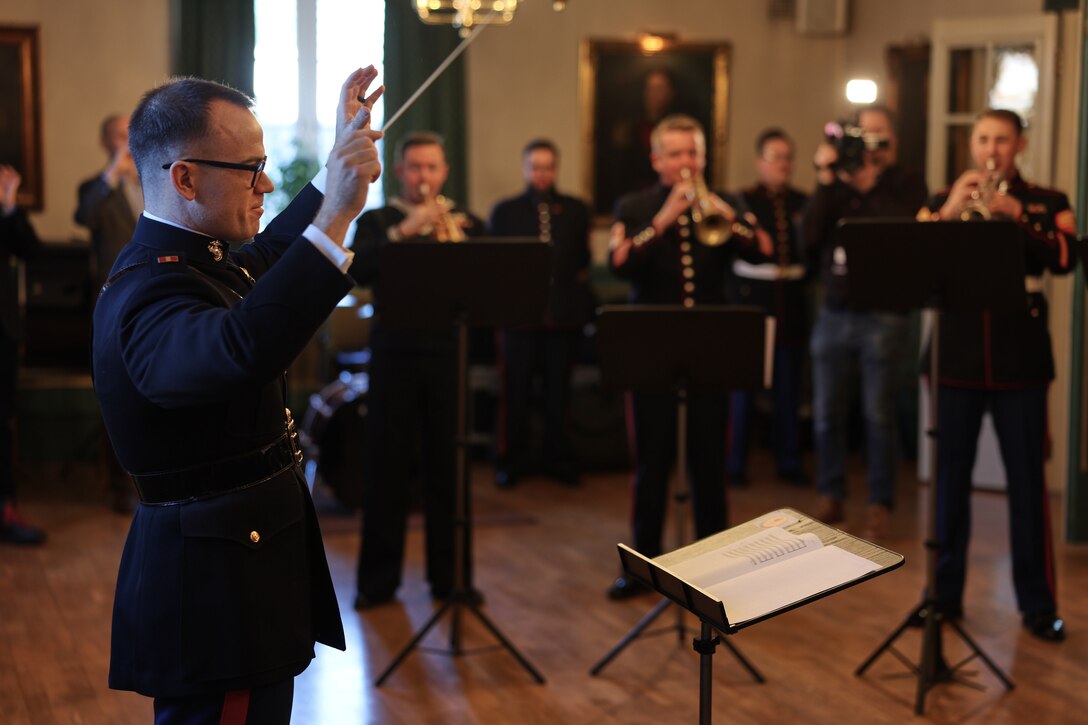U.S. Marine Corps Warrant Officer Nathan Doggett, U.S. Marine Corps band member, left, conducts members of the Nordic band element during the preparation phase of Exercise Nordic Response 24 in Oslo, Norway, Mar. 6, 2024. Military band members from Norway, Sweden, Finland, and the U.S. have gathered amidst Nordic Response 24 to symbolize the growth and camaraderie of the nations. This ensemble will play in various locations around Europe during the military exercise. (U.S. Marine Corps photo by Lance Cpl. Garrett Gillespie)
