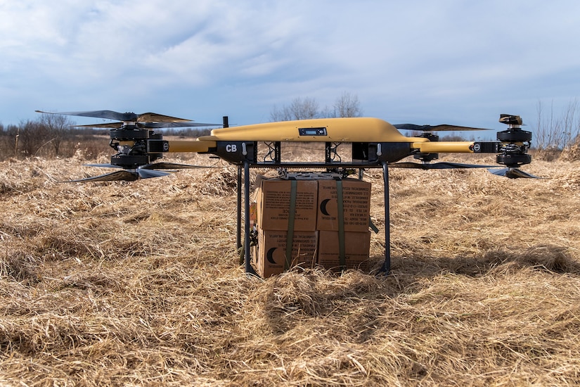 A military drone holds a package.