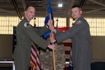 Col. Brock E. Lange, left, 192nd Wing commander, passes the 192nd Operations Group guidon to Col. Andrew M. Weidner signifying his assumption of command of the group March 1, 2024, at Joint Base Langley-Eustis in Hampton, Virginia. Col. Philip J. Colomy relinquished command of the group to Weidner, previously the 192nd OG deputy commander, during the change of command ceremony. (U.S. Air National Guard photo by Tech. Sgt. Johnisa Jackson)