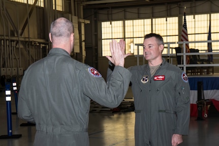 Two officers standing with right hand raised