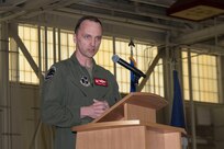 Col. Brock E. Lange stands at a podium