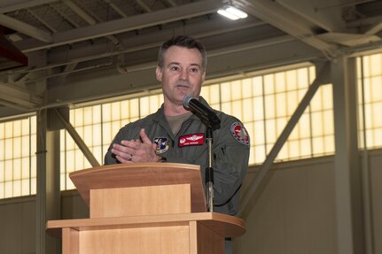 Col. Andrew M. Weidner stands at a podium