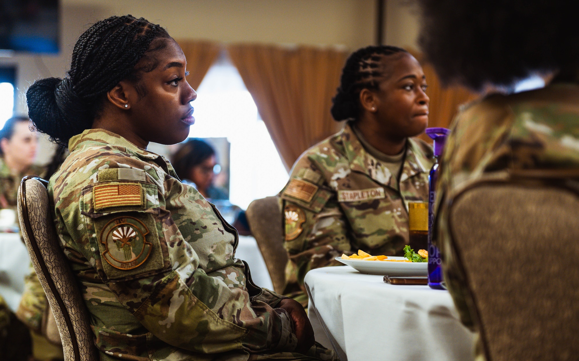 U.S. Air Force Tech. Sgt. Allison Mebane, 56th Logistics Readiness Squadron individual protective equipment supervisor, listens to a speech at a Women’s History Month exposition.