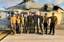 The crew of a U.S. Navy Helicopter Sea Combat Squadron 25 (HSC-25) MH-60S Knighthawk helicopter stand for a photo on March 6, 2024, at Andersen Air Force Bse after effectively evacuated a U.S. Coast Guard member from the USCGC Polar Star (WAGB 10), 100 nautical miles south of Guam, in a joint effort. The incident began on March 5, when the Joint Rescue Sub-Center (JRSC) Guam received a communication from the Polar Star crew regarding a 43-year-old man aboard experiencing severe abdominal pain. Recognizing the need for urgent medical attention beyond the capabilities available on ship, watchstanders directed the cutter to reroute closer to Guam and initiate a medical evacuation. (U.S. Navy photo by Petty Officer 2nd Class Matthew Thomas)



SAR, JRSC, Guam, medevac, HSC-25