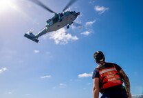 On March 6, 2024, the U.S. Coast Guard and U.S. Navy's Helicopter Sea Combat Squadron 25 (HSC-25) effectively evacuated a U.S. Coast Guard member from the USCGC Polar Star (WAGB 10), 100 nautical miles south of Guam, in a joint effort. The incident began on March 5, when the Joint Rescue Sub-Center (JRSC) Guam received a communication from the Polar Star crew regarding a 43-year-old man aboard experiencing severe abdominal pain. Recognizing the need for urgent medical attention beyond the capabilities available on ship, watchstanders directed the cutter to reroute closer to Guam and initiate a medical evacuation. (U.S. Coast Guard photo by Petty Officer 2nd Class Ryan Graves)