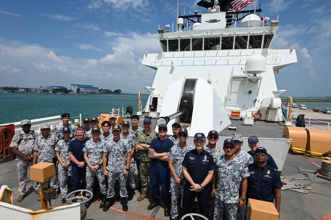 Members from U.S. Coast Guard Cutter Bertholf (WMSL 750) stand with individuals from the Republic of Singapore Navy, Police Coast Guard, and the Malaysian Maritime Enforcement Agency after completing a tour aboard the cutter while it was moored in Singapore on Feb. 26, 2024. The Bertholf is a National Security Cutter and is home ported in Alameda, Calif. (U.S. Coast Guard photo by Petty Officer Steve Strohmaier)