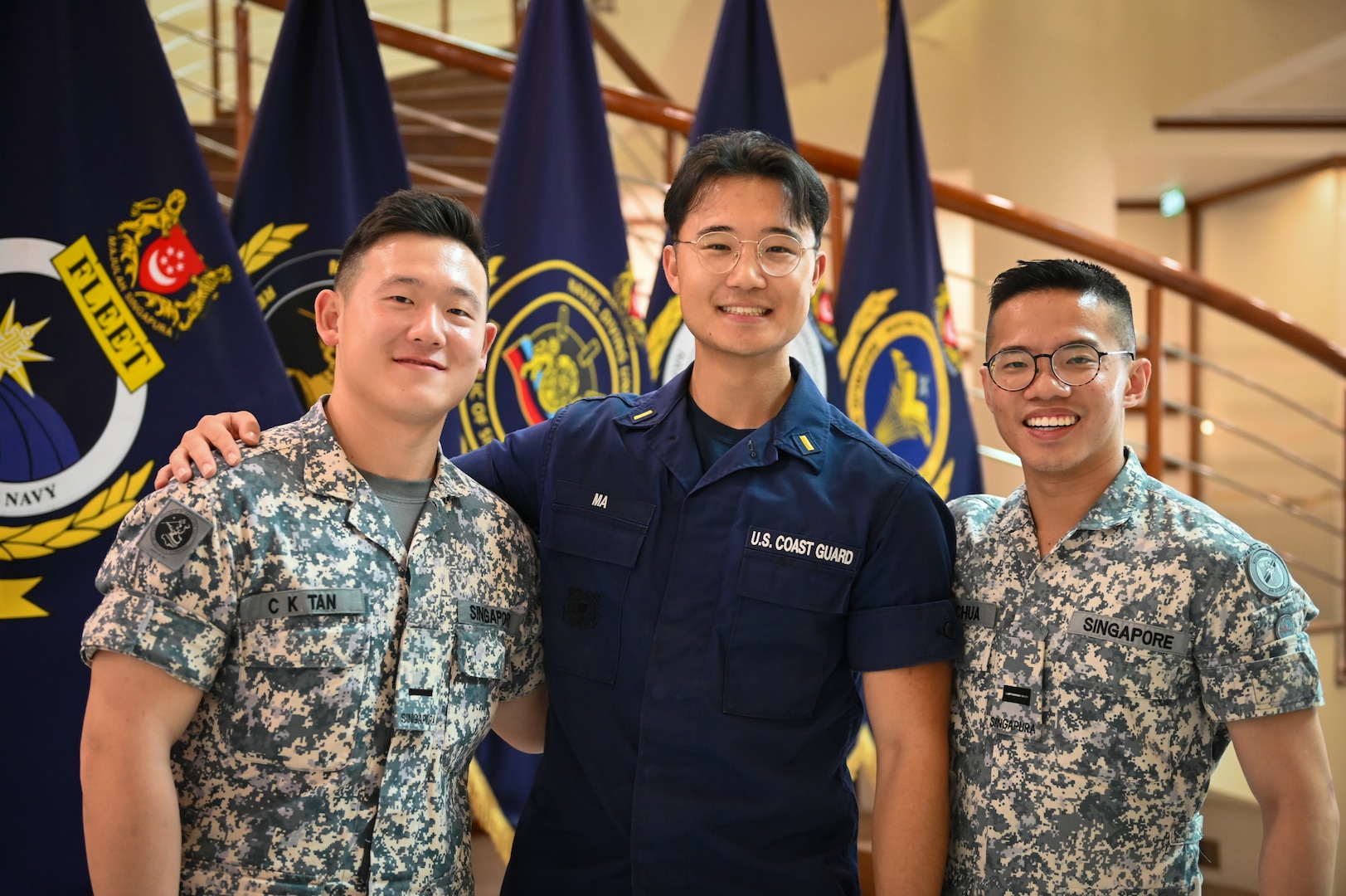 Ens. Tyler Ma, a crewmember from U.S. Coast Guard Cutter Bertholf (WMSL 750), stands with two members of the Republic of Singapore Navy following a ceremony at the Changi Navy Base in Singapore on Feb. 26, 2024. Following the ceremony, crews from both the Bertholf and the Republic of Singapore Navy socialized about their experiences in their respective sea-going services. (U.S. Coast Guard photo by Petty Officer Steve Strohmaier)