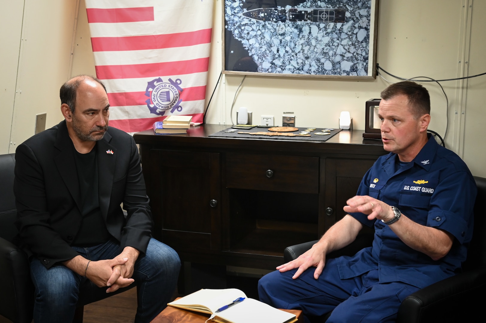 Capt. Billy Mees, commanding officer of U.S. Coast Guard Cutter Bertholf (WMSL 750), speaks with Mr. Jonathan Kaplan, U.S. Ambassador to Singapore, during a meeting aboard the cutter while it was moored in Singapore, Feb. 27, 2024. Bertholf is deployed to the Indo-Pacific region to advance relationships with ally and partner nations. (U.S. Coast Guard photo by Petty Officer Steve Strohmaier)