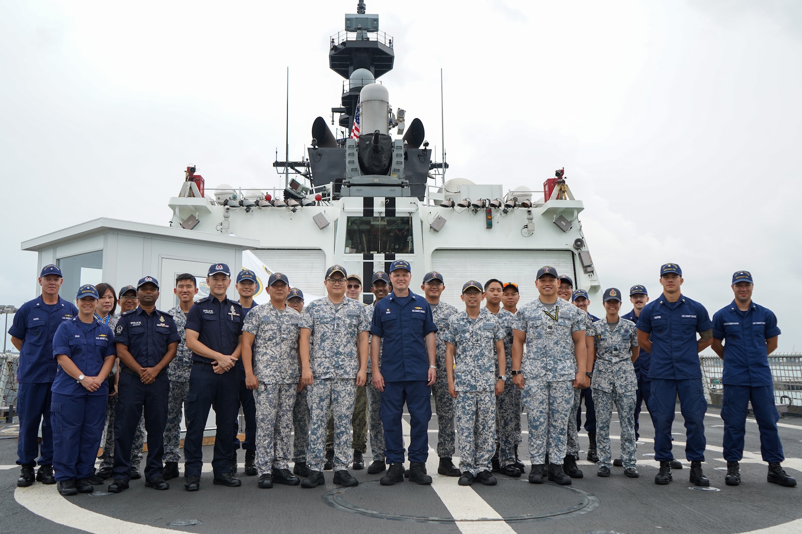 Crewmembers from U.S. Coast Guard Cutter Bertholf (WMSL 750) stand with individuals from the Republic of Singapore Navy and the Singapore Police Coast Guard, after completing a tour aboard the cutter while it was moored in Singapore on Feb. 27, 2024. The Bertholf is a National Security Cutter and can carry a crew of up to 170 people. (U.S. Coast Guard photo by Petty Officer Steve Strohmaier)