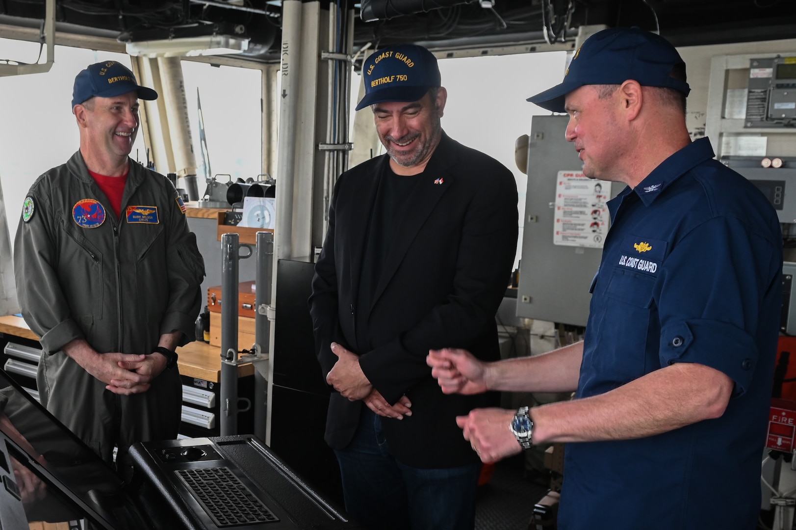 Capt. Billy Mees, commanding officer of U.S. Coast Guard Cutter Bertholf (WMSL 750), speaks with Mr. Jonathan Kaplan, U.S. Ambassador to Singapore, and Rear Adm. Mark Melson, commander, logistics Western Pacific, during a tour of the bridge while the cutter was moored in Singapore, Feb. 27, 2024. The crew of the Bertholf is on a several-month deployment to promote a free and open Indo-Pacific. (U.S. Coast Guard photo by Petty Officer Steve Strohmaier)