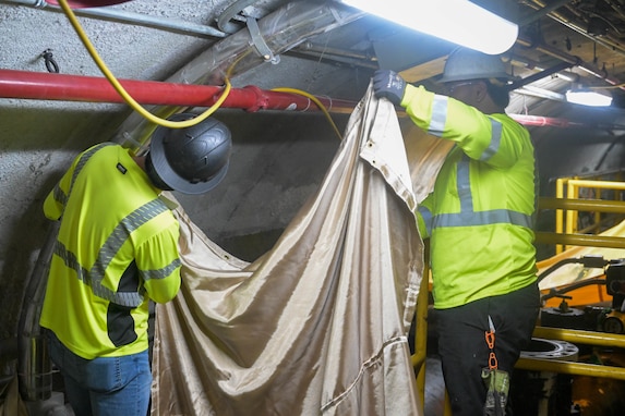 Personnel in support of Joint Task Force-Red Hill (JTF-RH) set up protective curtains prior to cutting into pipe lines at the Red Hill Bulk Fuel Storage Facility (RHBFSF), Halawa, Hawaii, March 11, 2024.