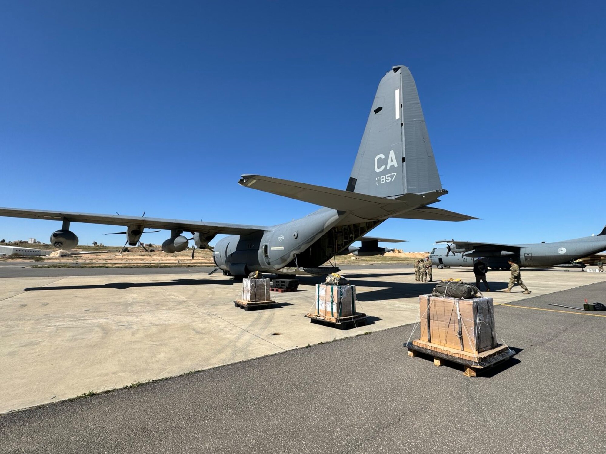 Coalition Airmen from the U.S. and Jordan load Jordanian humanitarian aid aboard a HC-130J aircraft.