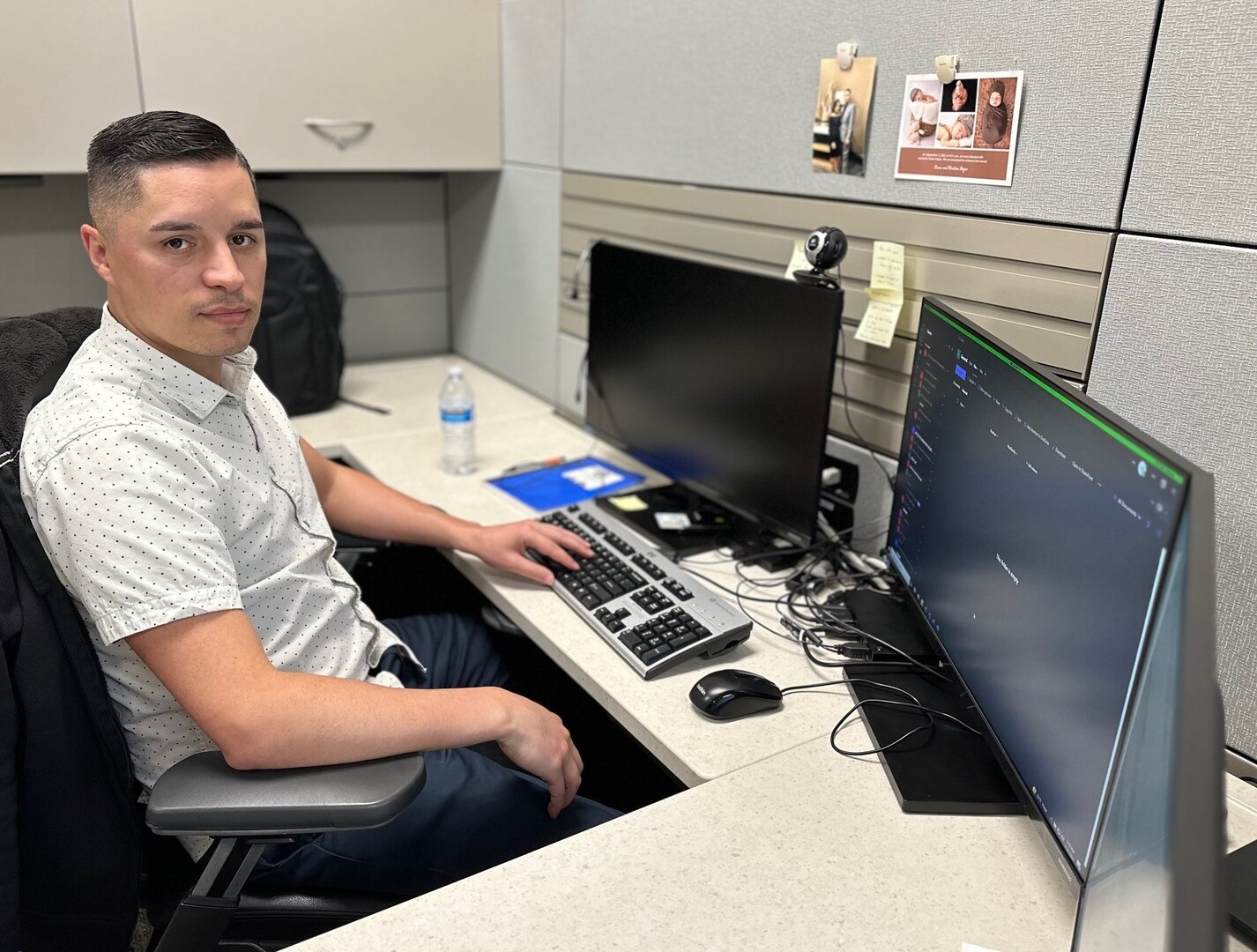 Photo of Rosado sitting at his desk looking at the camera