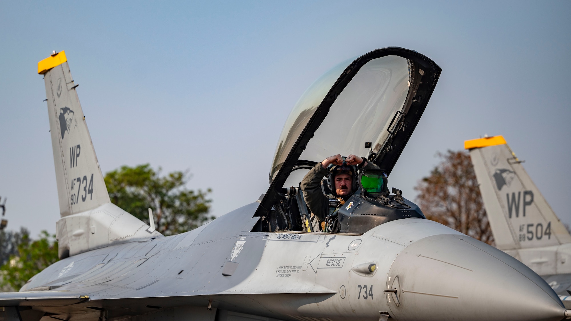 Maj. Robert Glenn, 80th Fighter Squadron director of operations, performs a gesture of squadron pride before flight