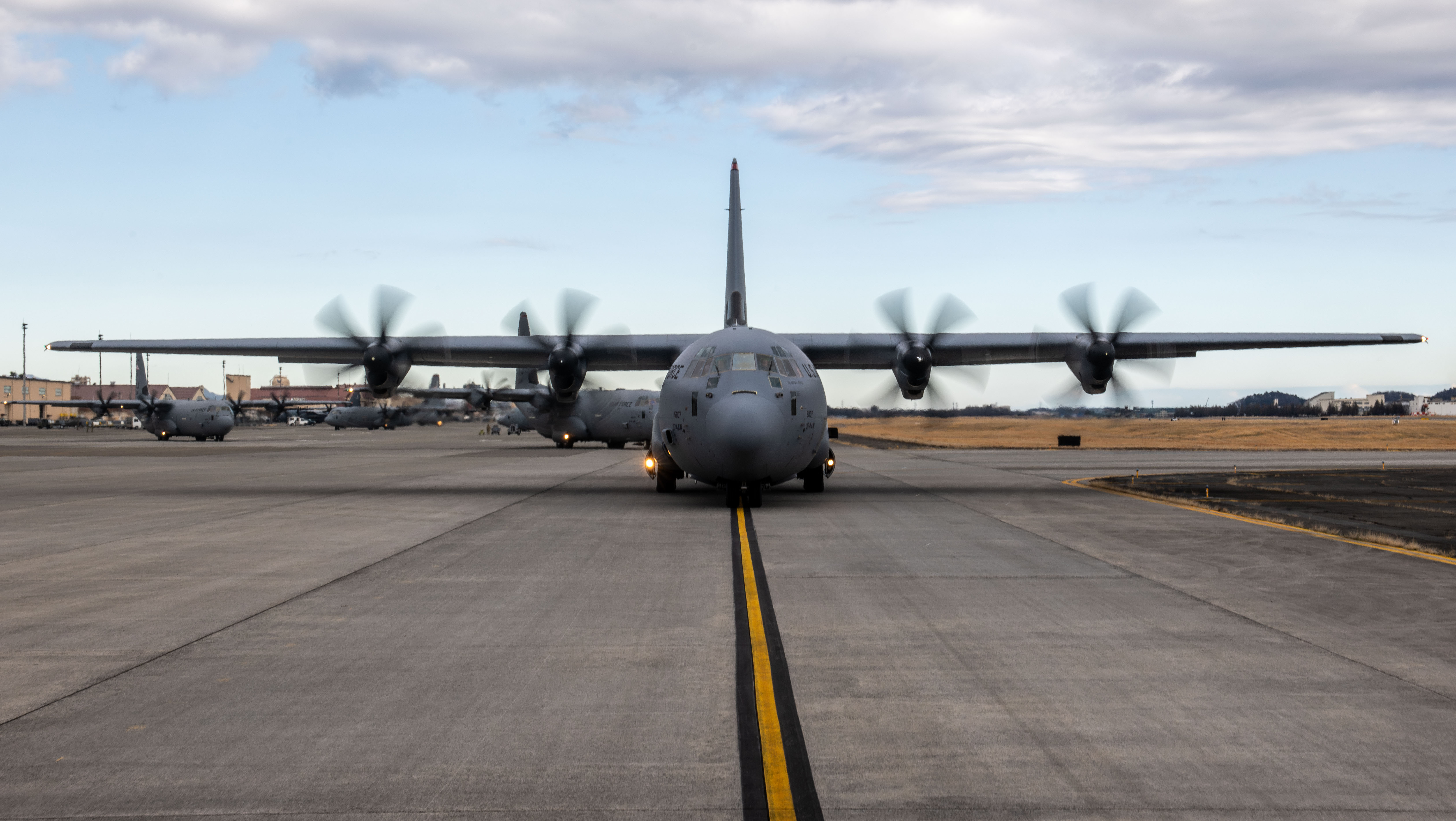 Six C-130Js taxi on the flightline to conduct training operations for static-line jump training during Airborne 24