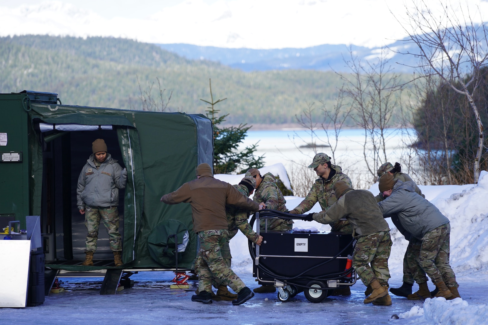 Alaska and Maine Air National Guardsmen move a power generator while disassembling an Expandable Single Pallet Expeditionary Kitchen during Exercise Vigilant Guard 2024-2 (Alaska) at Cordova, Alaska, March 6, 2024. The full-scale exercise was designed to ensure effective coordination and emergency response among local, state, private sector, non-governmental organizations and federal partners in the event of a natural disaster.