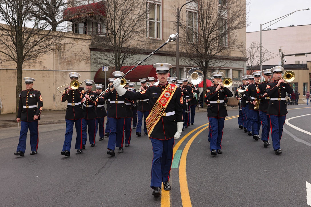 U.S. Marine Corps Staff Sgt. Lucas T. DeValder, drum major with the Quantico Marine Band, a New York native, leads the band during the St. Patricks’ Day Parade in Scranton, Pennsylvania, March 9, 2024. The band provides musical support that enhances community relations and troop morale, and promotes the Marine Corps recruiting program through events such as parades, concerts, and ceremonies. (U.S. Marine Corps photo by Lance Cpl. David Brandes)