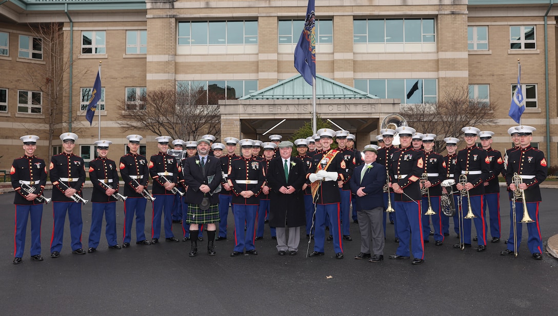 The Quantico Marine Band stands with Scranton St. Patricks’ Day liaisons in Scranton, Pennsylvania, March 9, 2024. The band provides musical support that enhances community relations and troop morale, and promotes the Marine Corps recruiting program through events such as parades, concerts, and ceremonies. (U.S. Marine Corps photo by Lance Cpl. David Brandes)