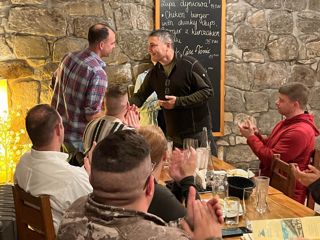 Maj. Gen. Paul Knapp, Wisconsin’s adjutant general, presents a challenge coin to Maj. Joe Trovato, commander of the Wisconsin Army National Guard’s 112th Mobile Public Affairs Detachment, during a senior leader visit in November 2023 to the deployed unit in Bolesławiec, Poland. The detachment supported the public affairs mission of Operation Assure, Deter and Reinforce in Eastern Europe. 112th Mobile Public Affairs photo