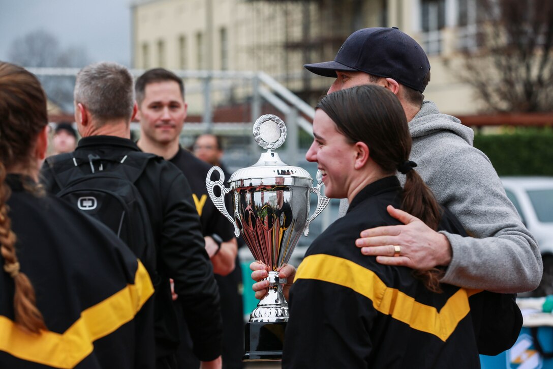 West Point Cadet Kacy Colletto celebrates with the Lions Legacy trophy during the U.S. Army South European Task Force, Africa Lion’s Legacy series, hosted at Caserma Ederle, Vicenza, Italy on March 8, 2024. Lions Legacy is designed to enhance unit cohesion and teamwork through a series of physical challenges. (U.S. Army photo by Spc. Ebony Neal)