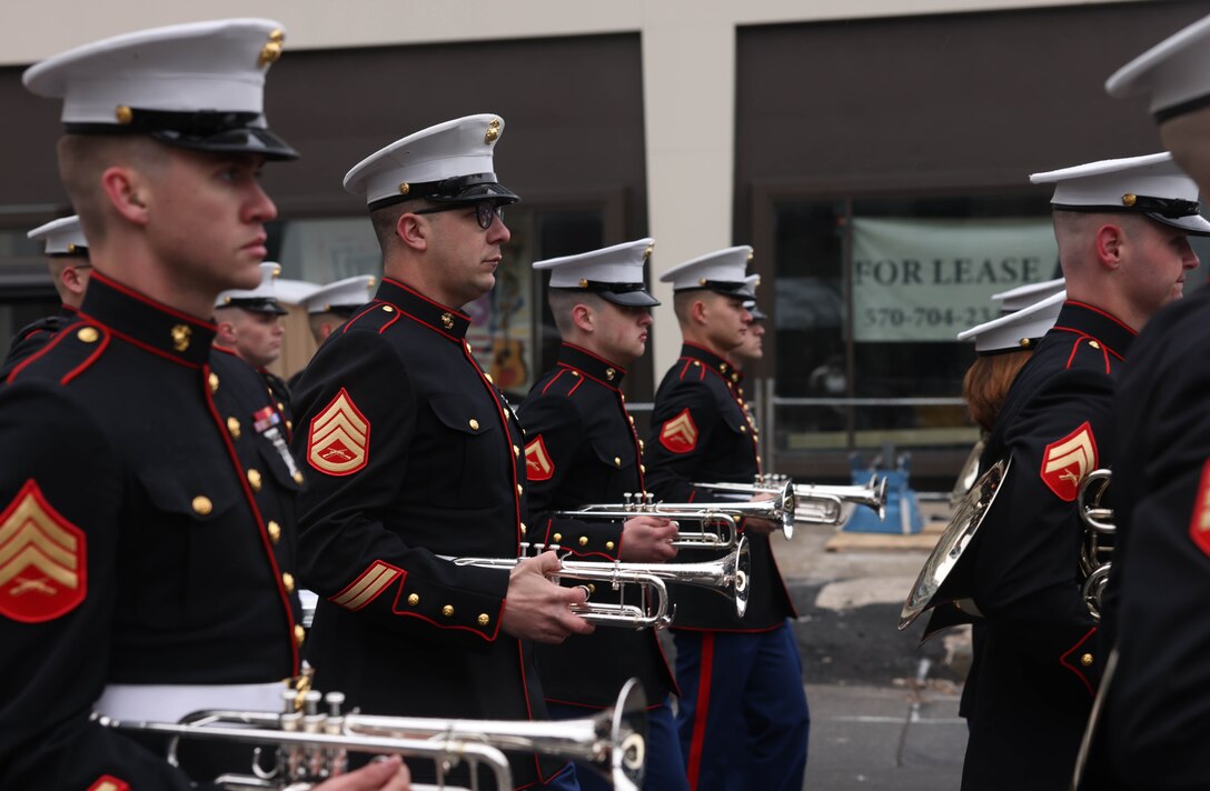 U.S. Marines with the Quantico Marine Band march during the St. Patricks’ Day Parade in Scranton, Pennsylvania, March 9, 2024. The band provides musical support that enhances community relations and troop morale, and promotes the Marine Corps recruiting program through events such as parades, concerts, and ceremonies. (U.S. Marine Corps photo by Lance Cpl. David Brandes)
