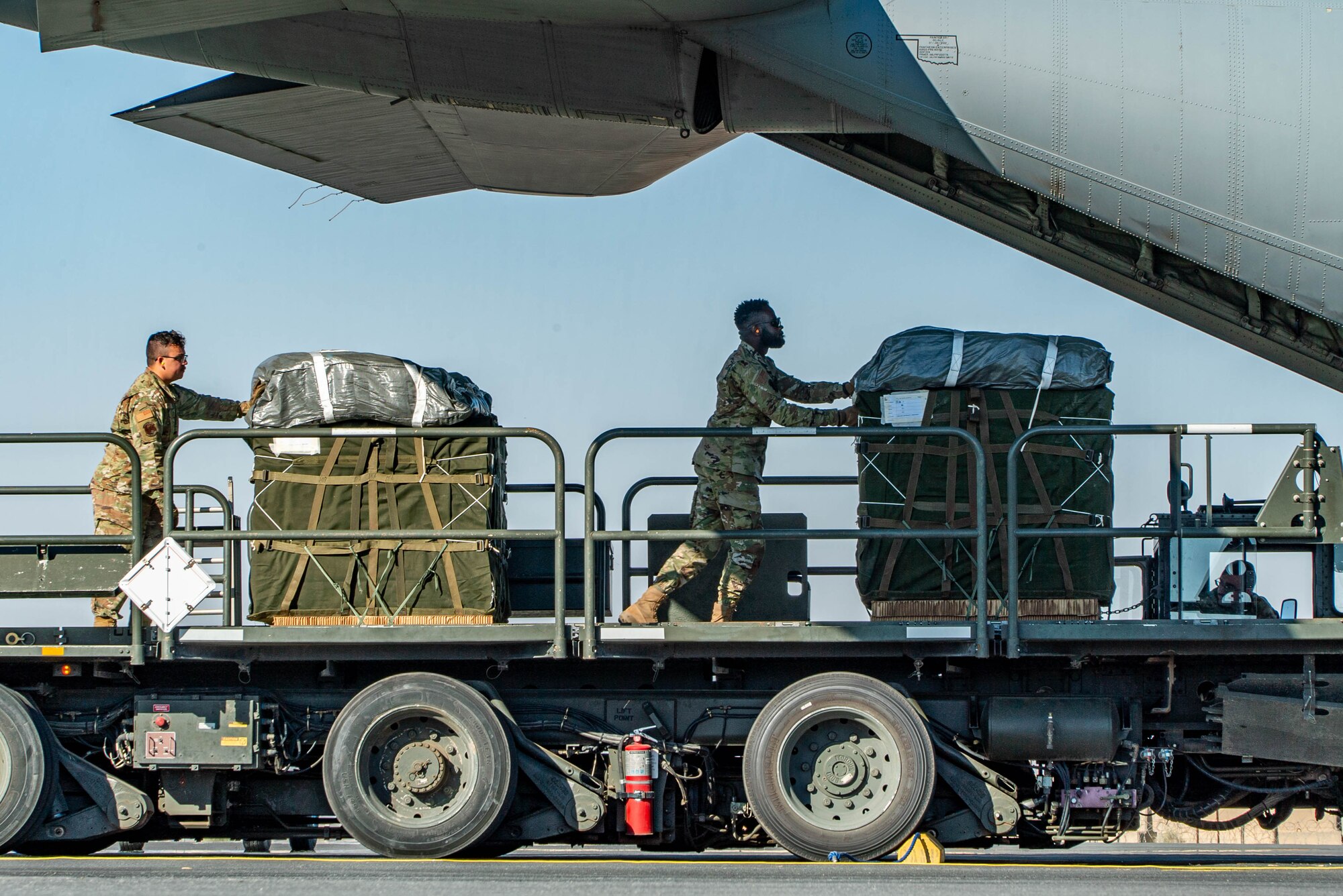 Airmen load humanitarian aid bound for airdrop over Gaza aboard a C-130J.