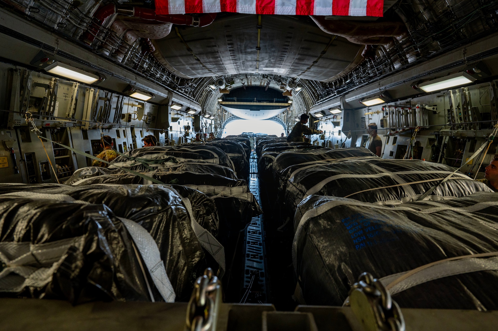 Humanitarian aid pallets destined for Gaza are prepared for airdrop aboard a C-17.