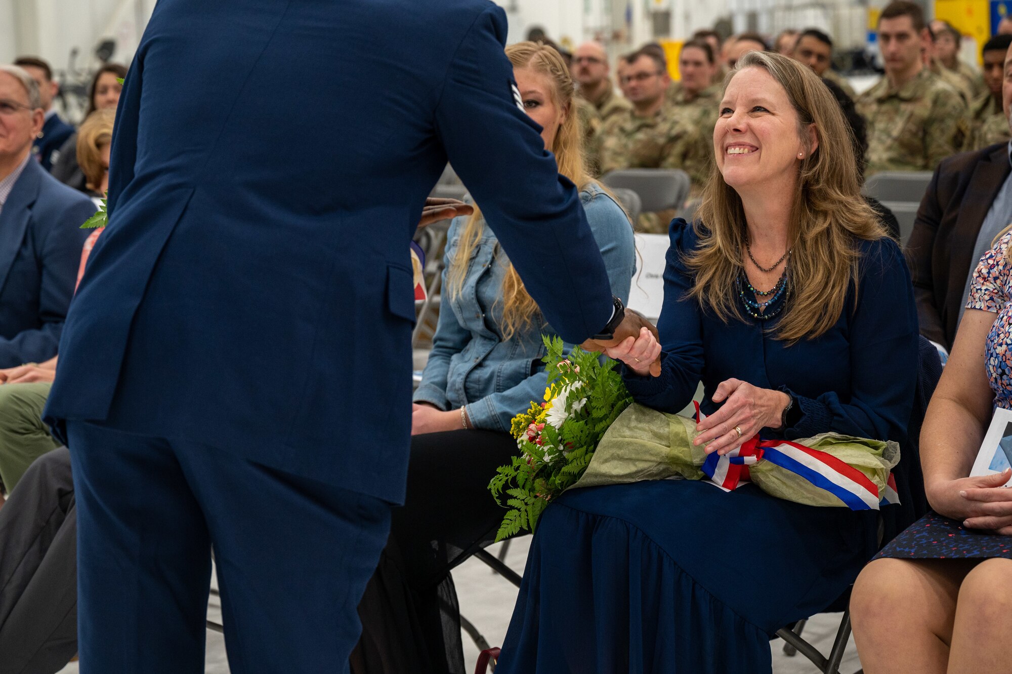 A woman accepts a bouquet of flowers