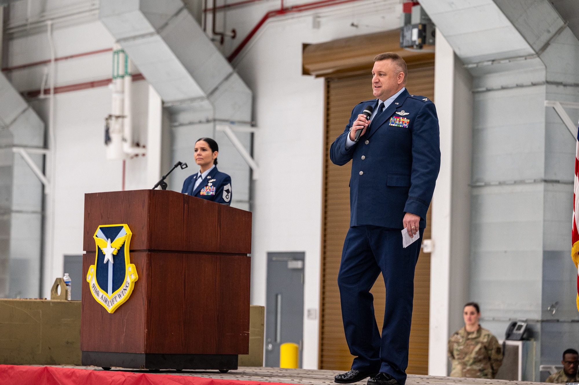 A man in uniform speaking into a microphone