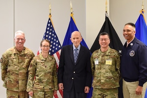 Image of people and Airmen presenting at a conference.