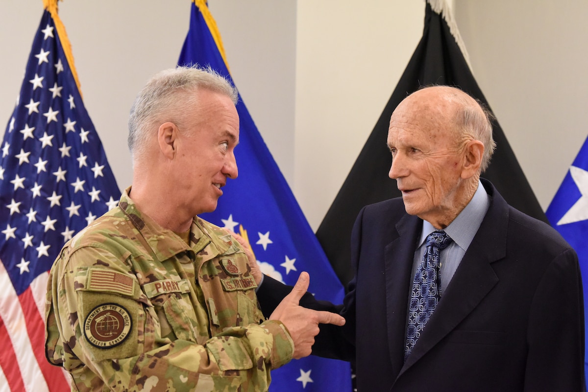 Image of people and Airmen presenting at a conference.