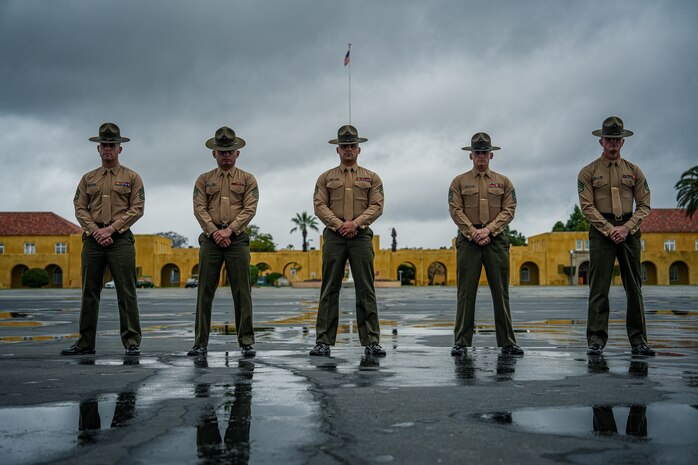 U.S. Marine Corps drill masters with Marine Corps Recruit Depot San Diego, pose for a group photo on the parade parade deck at MCRD San Diego, California, Mar. 2, 2024. During final drill evaluation, the platoons are scored based on their uniform, bearing, and movements, as well as the senior drill instructor's cadence, sword manual, and movement commands. (U.S. Marine Corps photo by Lance Cpl. Francisco Angel)