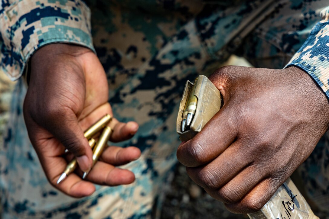 U.S. Marine Corps Sgt. Brandford Asomaning Jr., an inventory management specialist with Task Force Koa Moana 23, reloads magazines during a range shoot at the Joint Range Complex in Ngatpang, Palau, Sept. 22, 2023. Task Force Koa Moana 23, composed of U.S. Marines and Sailors from I Marine Expeditionary Force, deployed to the Indo-Pacific to strengthen relationships with Pacific Island partners through bilateral and multilateral security cooperation and community engagements. (U.S. Marine Corps photo by Staff Sgt. Courtney G. White)