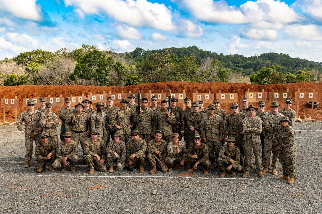 U.S. Marines and Sailors with Task Force Koa Moana 23 pose for a photograph at the conclusion of a range shoot at the Joint Range Complex in Ngatpang, Palau, Sept. 22, 2023. Task Force Koa Moana 23, composed of U.S. Marines and Sailors from I Marine Expeditionary Force, deployed to the Indo-Pacific to strengthen relationships with Pacific Island partners through bilateral and multilateral security cooperation and community engagements. (U.S. Marine Corps photo by Staff Sgt. Courtney G. White)