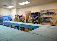 Tech. Sgt. Hilda Mata-Betancourt, 383rd Training Squadron surgical technology course instructor, guides leadership from the 59th Medical Wing through various classrooms, showcasing commonly used equipment by technical training students at the 59th Training Group, Joint Base San Antonio-Fort Sam Houston, Texas, March 1, 2024. The training group offers comprehensive healthcare education to support both the Air Force Medical Service and the Defense Health Agency. (U.S. Air Force photo by Senior Airman Melody Bordeaux)