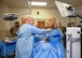 After donning the appropriate personal protective equipment, leadership from the 59th Medical Wing participate in an extraction procedure training technical students receive at the 59th Training Group, Joint Base San Antonio-Fort Sam Houston, Texas, March 1, 2024. The training group provides a full spectrum of healthcare education offering a continuum of learning, competency-based training, and credentialing within a tri-service environment.  (U.S. Air Force photo by Senior Airman Melody Bordeaux)