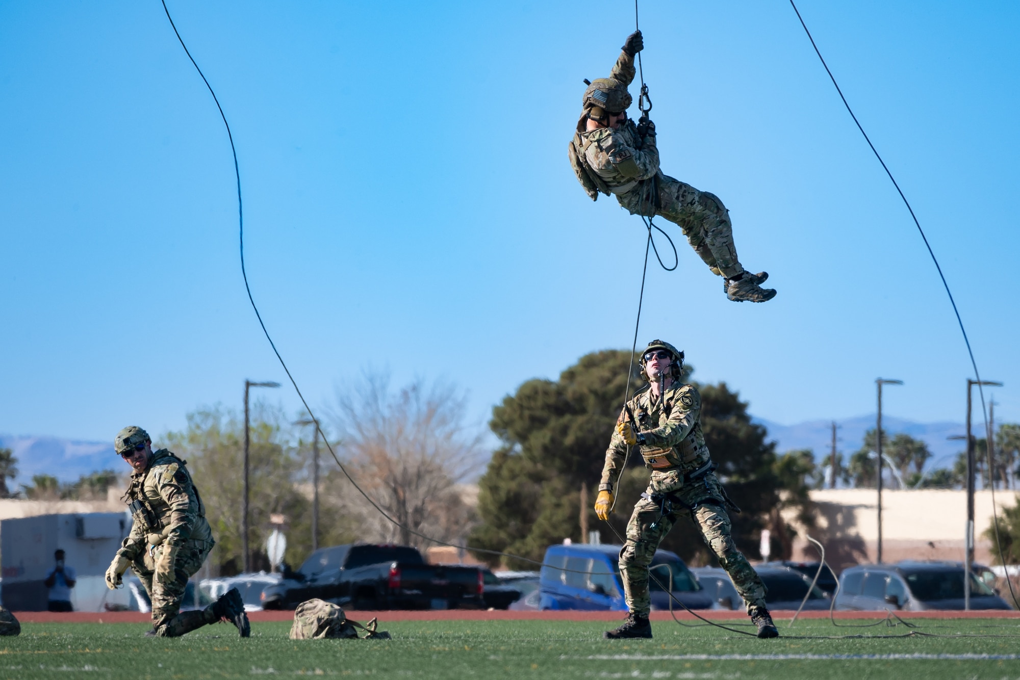 U.S. Air Force Airmen assigned to the Air Force Special Warfare Exhibition team complete a fast rope infiltration demonstration in honor of the 2024 Air Force and Marine Corps Trials competition at Nellis Air Force Base, Nevada, March 8, 2024.