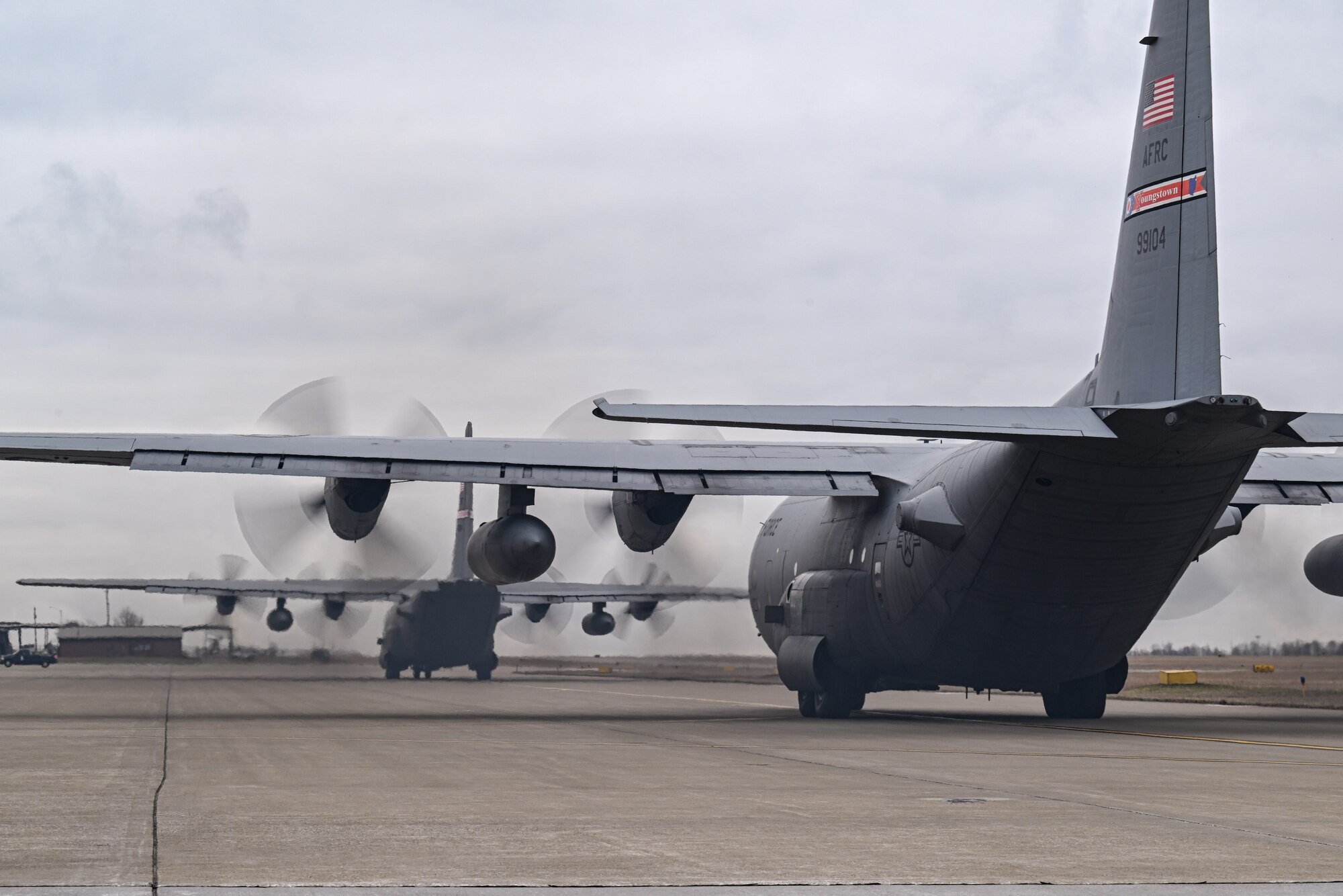 Two C-130H Hercules aircraft assigned to the 757th Airlift Squadron taxi down the flightline at Youngstown Air Reserve Station, Ohio, March 3, 2024.