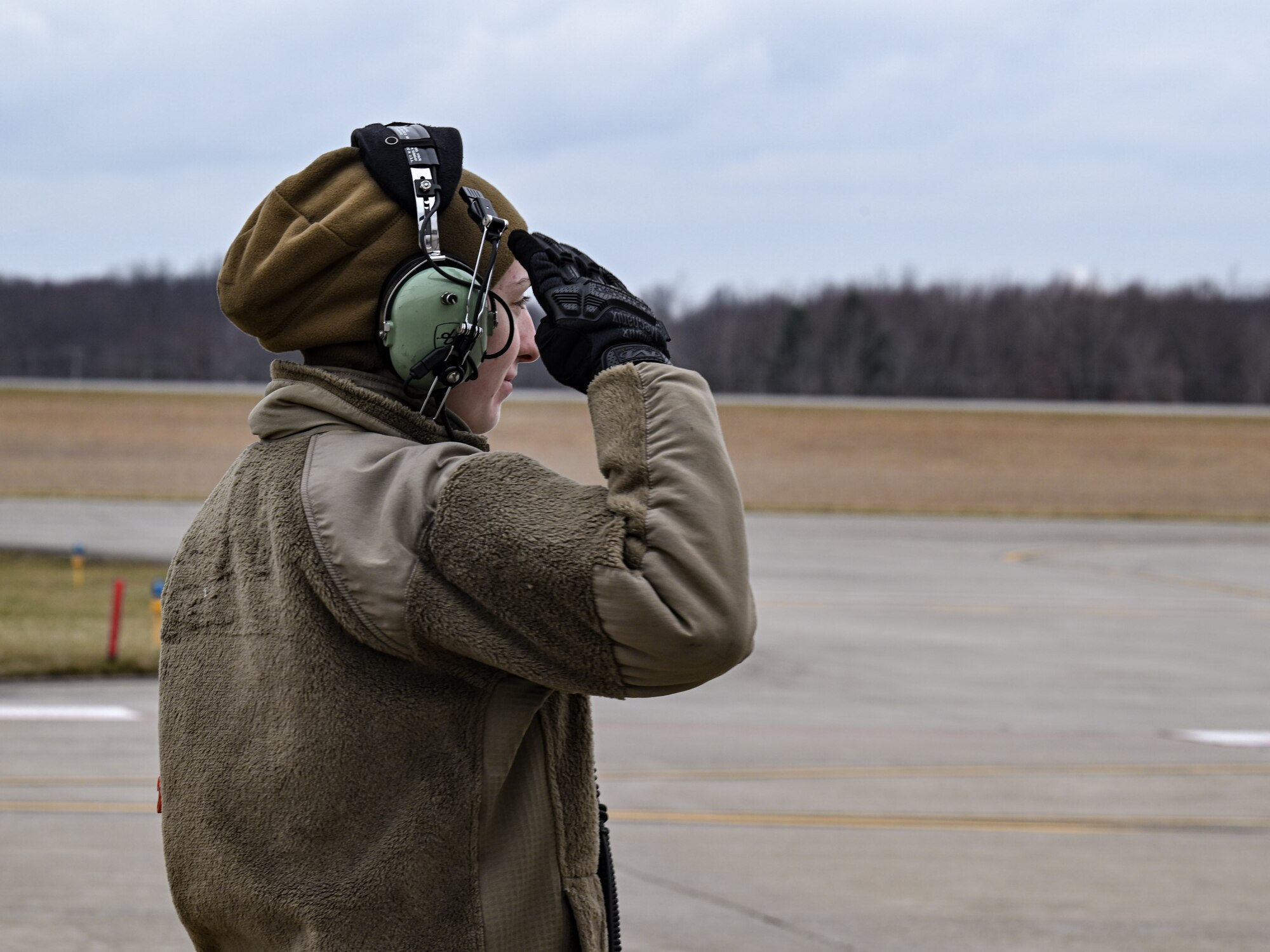 Staff Sgt. Sydney Lewis, a crew chief with the 910th Aircraft Maintenance Squadron, salutes a C-130H Hercules aircraft pilot at Youngstown Air Reserve Station, Ohio, March 3, 2024.