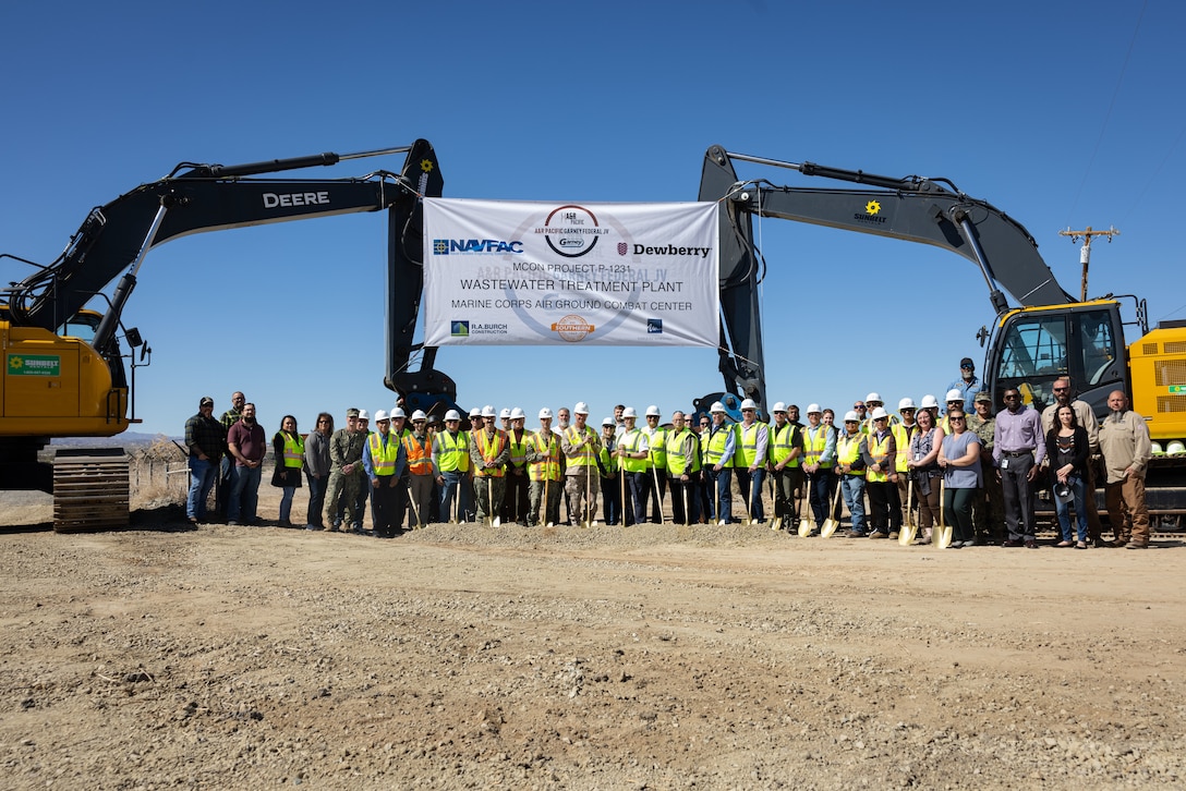 U.S. service members and ceremony guests from around Marine Corps Air-Ground Combat Center, along with contractors with A&R Pacific-Garney Federal Joint Venture, pose for a photo before a groundbreaking ceremony for the new wastewater treatment plant at MCAGCC, Twentynine Palms, California, March 6, 2024. The new WWTP project will decommission the current plant, construction of the new plant is expected to be completed in 2027. (U.S. Marine Corps photo by Sgt. Makayla Elizalde)