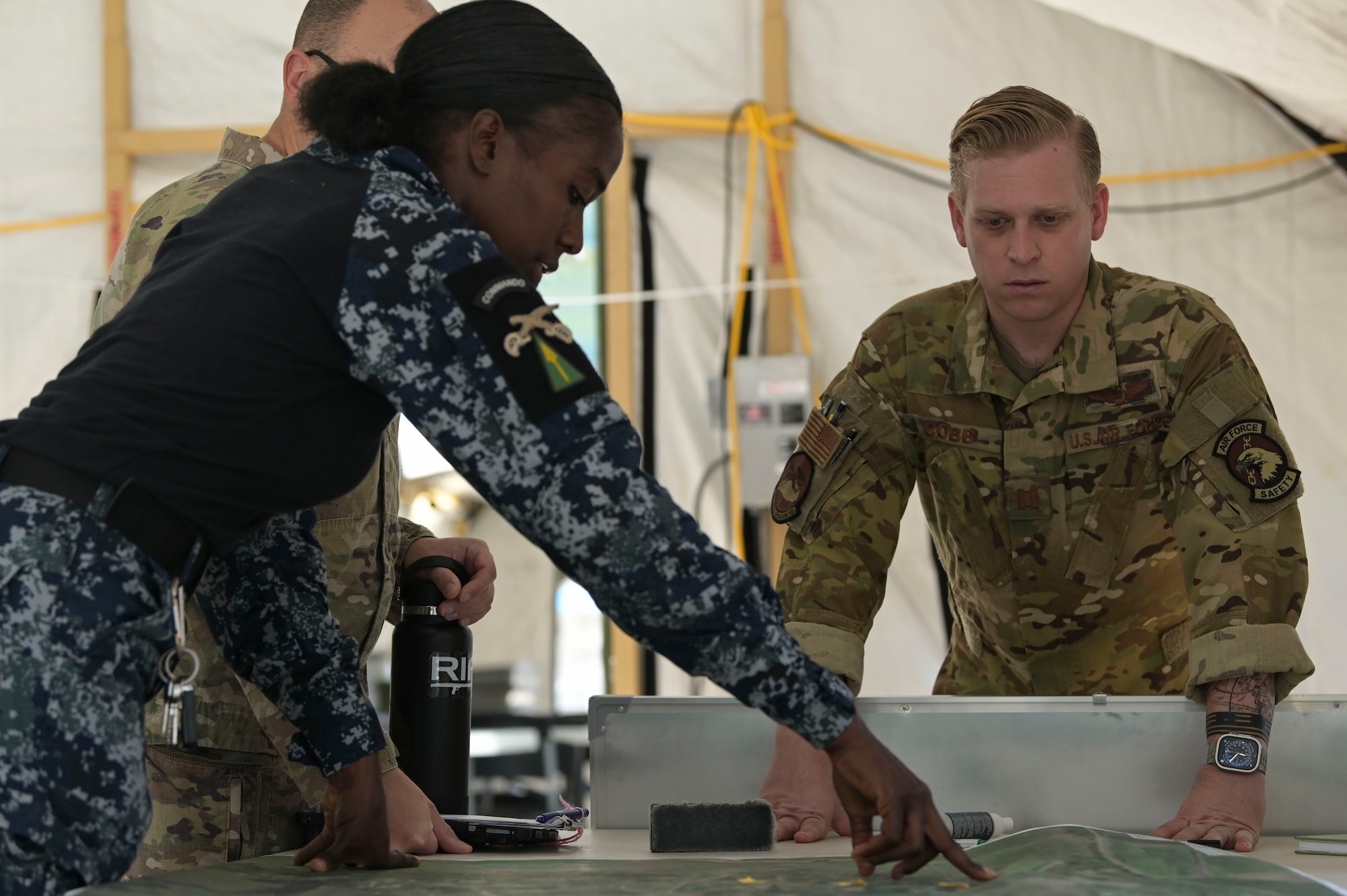 U.S. Air Force Capt. Ryan Cobb, a 34th Special Operations Squadron U-28 mission commander, plans with members of the Jamaica Defense Force during exercise Tropical Dagger at Kingston, Jamaica, Feb. 23, 2024.