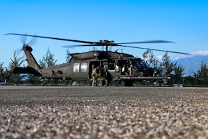 U.S. Ambassador to Jamaica, Nick Perry, sits on an MH-60M Black Hawk helicopter assigned to the 160th Special Operations Aviation Regiment, at Kingston, Jamaica, Feb. 28, 2024.