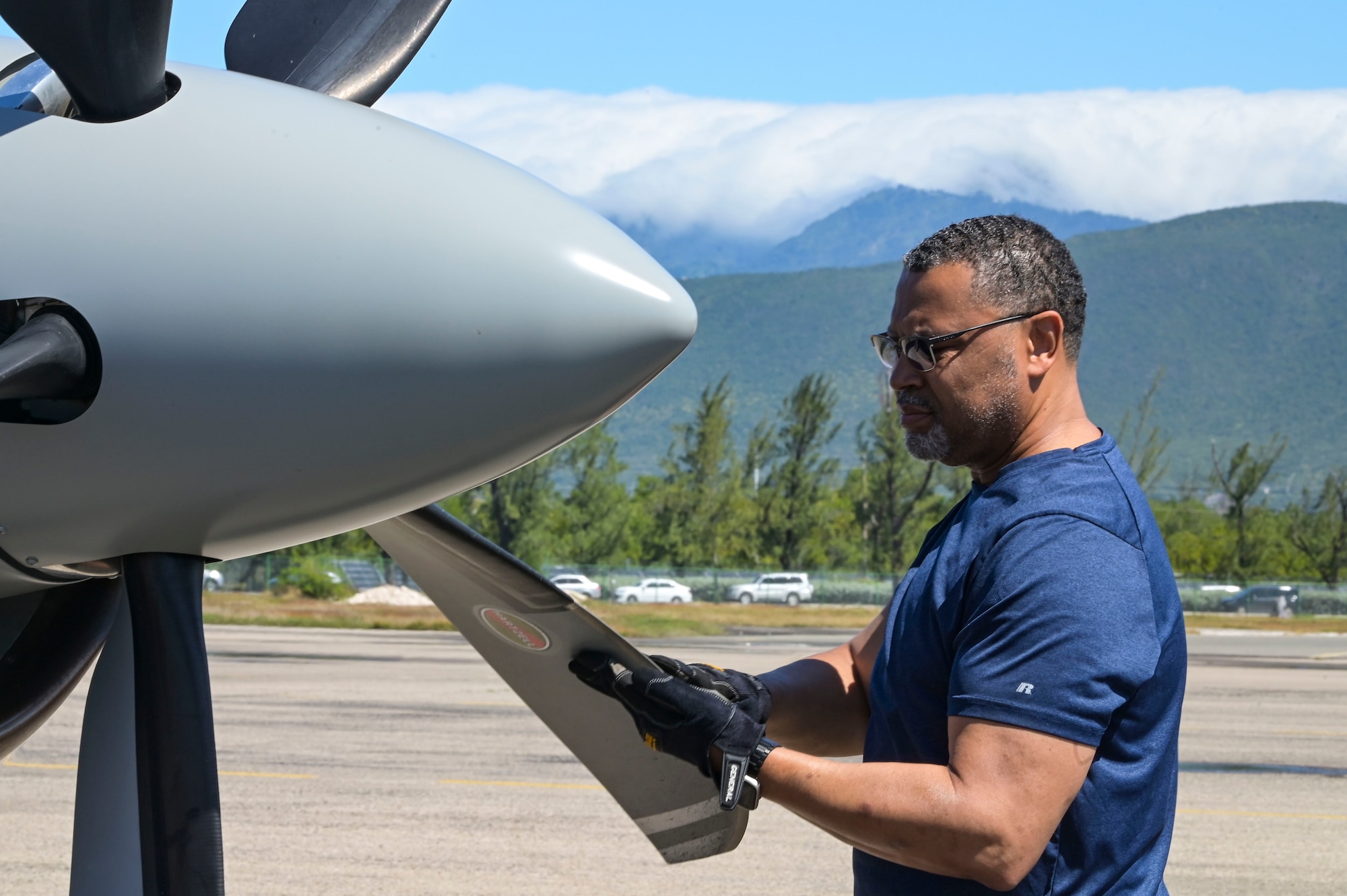 Patrick Wint, a 319th Special Operations Squadron field service technician, inspects a propeller on a U-28A Draco during exercise Tropical Dagger at Kingston, Jamaica, Feb. 21, 2024.