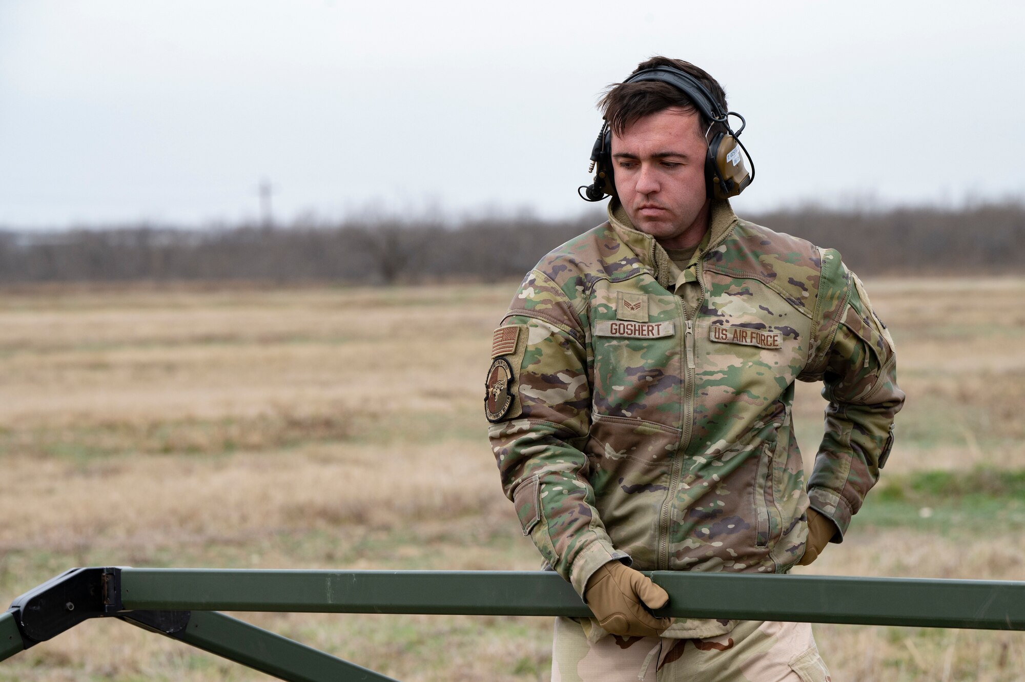 U.S. Air Force Senior Airman William Goshert, 39th Airlift Squadron crew chief, sets up a tent during the Hazard Dawn readiness exercise at Dyess Air Force Base Texas, Feb. 28, 2024. Practicing these procedures in a contested, degraded, and operationally limited environment prepares the wing for real-world scenarios. (U.S. Air Force photo by Airman 1st Class Emma Anderson)